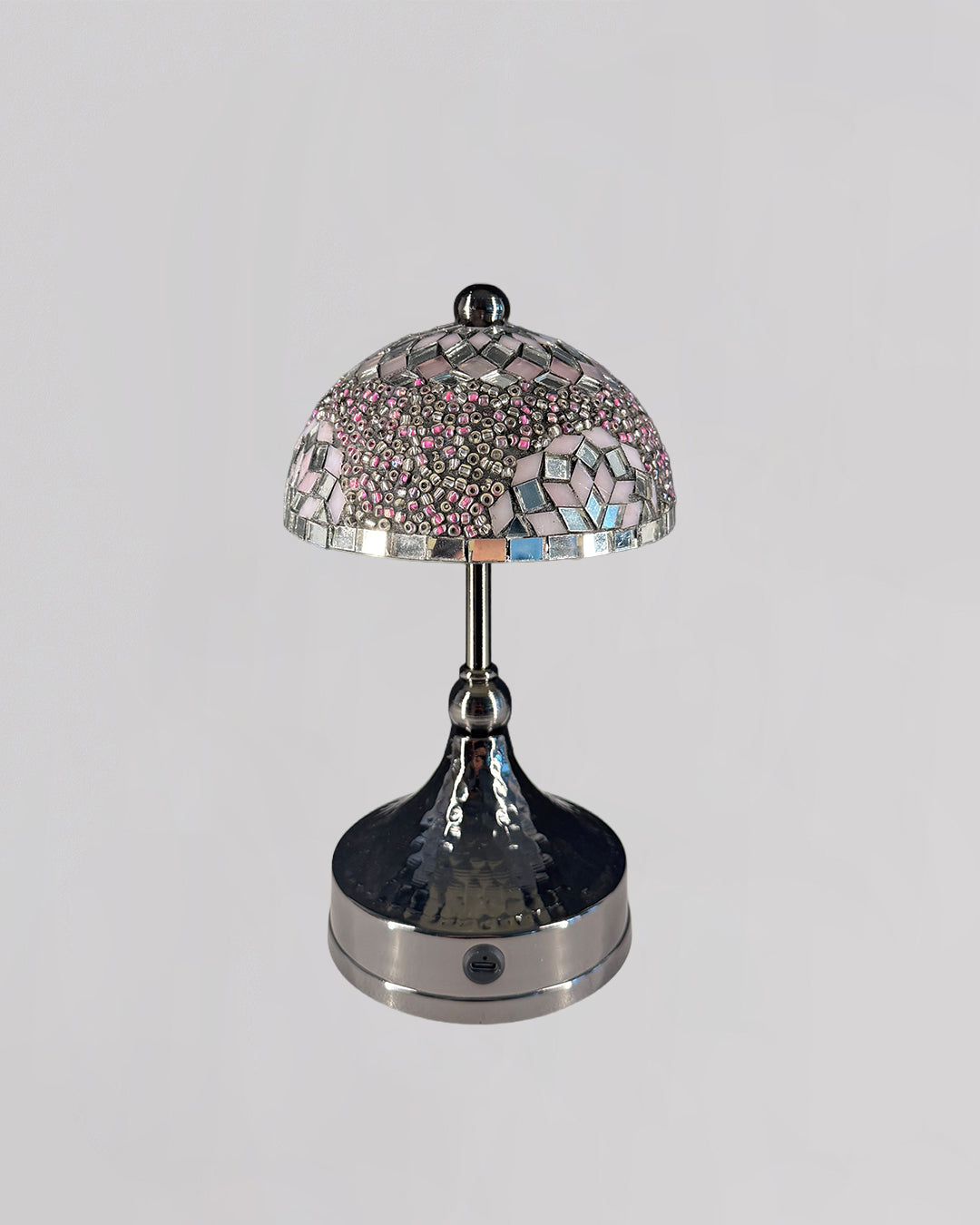 Decorative table lamp with a mosaic glass shade on a gray background