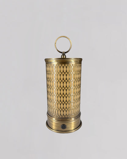 Brass lantern with intricate patterns on a light gray background