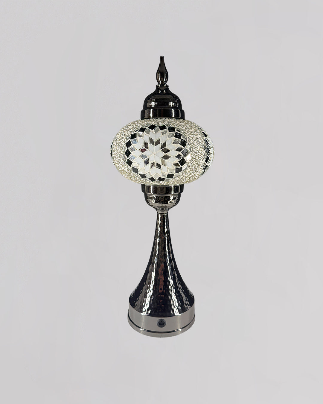 Decorative lamp with intricate design on a gray background