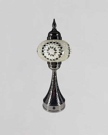 Decorative lamp with intricate design on a gray background