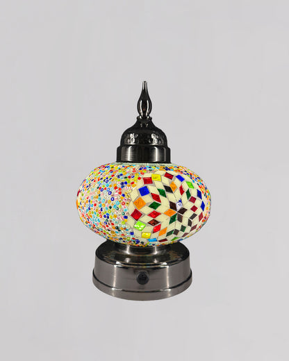Decorative lamp with a multicolored mosaic design on a gray background