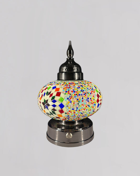 Decorative lamp with colorful mosaic design on a gray background