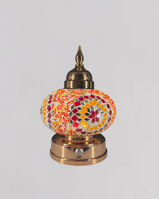 Decorative lamp with mosaic design on a white background