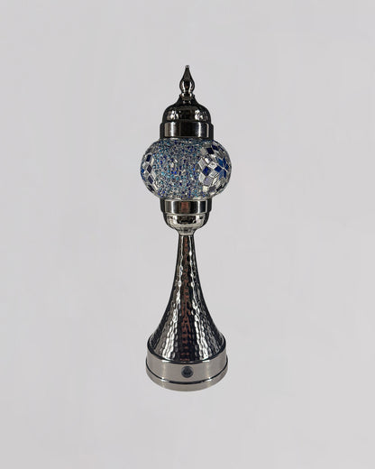 Decorative silver lamp with crystal embellishments on a white background