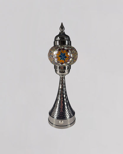 Decorative lamp with metallic and glass design on a white background