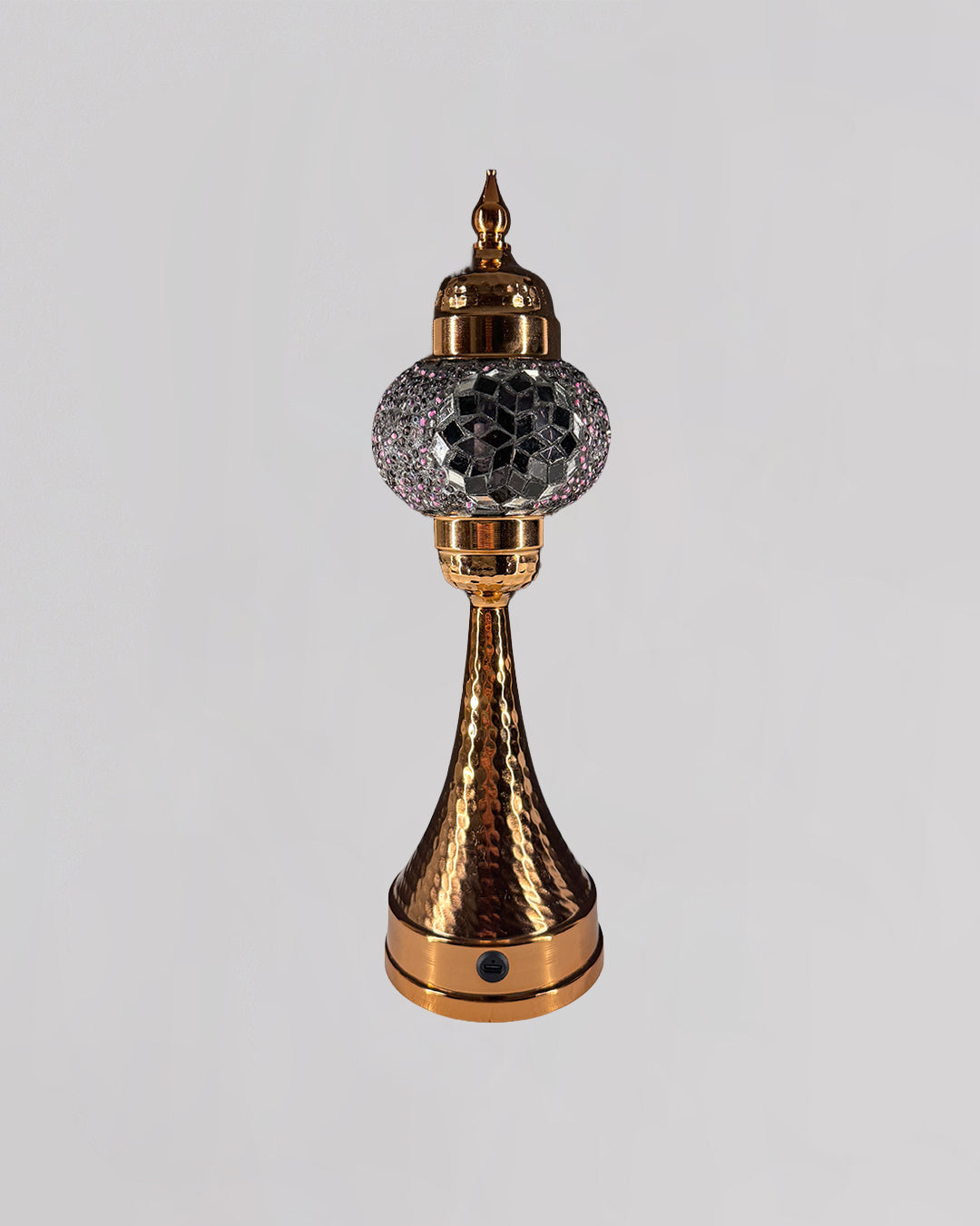 Decorative lamp with gold and crystal design on a light gray background