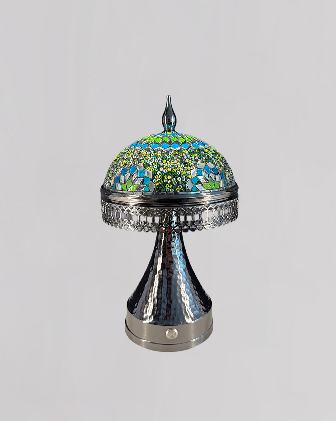 Decorative lamp with mosaic top and metallic base on a light gray background