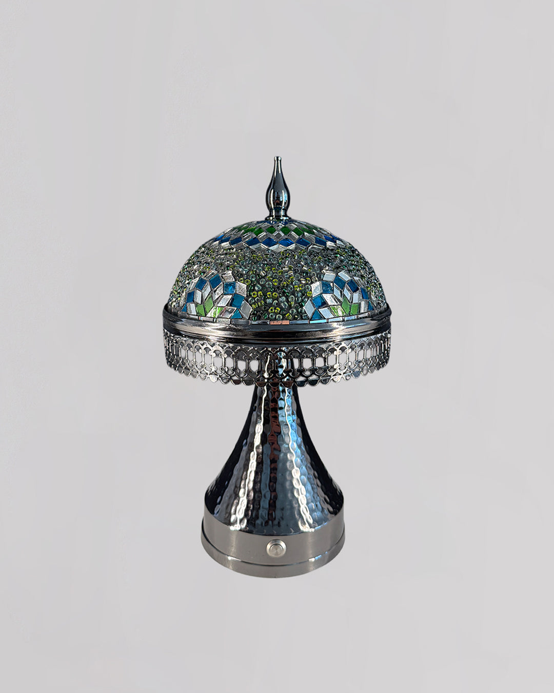 Decorative lamp with mosaic top and metallic base on a light gray background