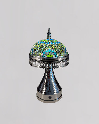 Decorative lamp with mosaic top and metallic base on a light gray background