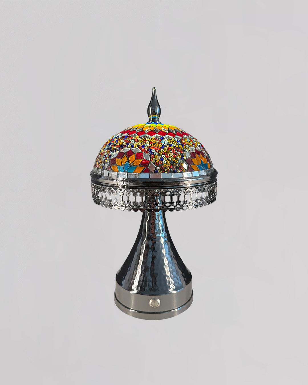 Decorative lamp with colorful mosaic top and metallic base on a gray background
