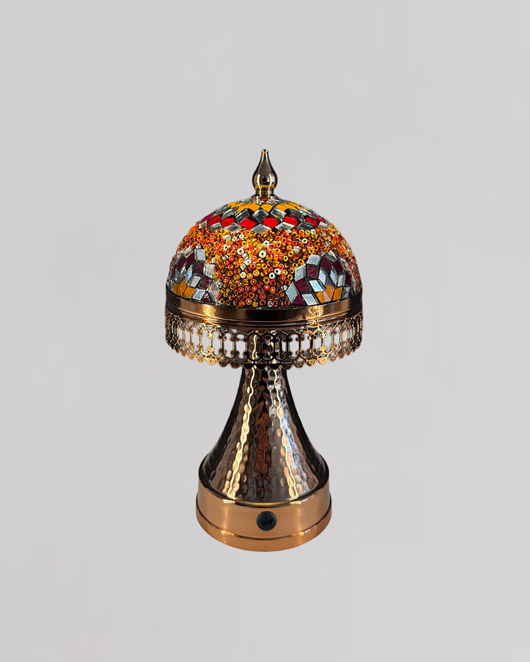 Decorative lamp with colorful mosaic top on a light gray background