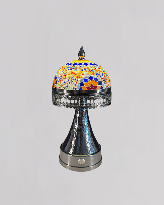 Decorative lamp with colorful mosaic top and metallic base on a gray background