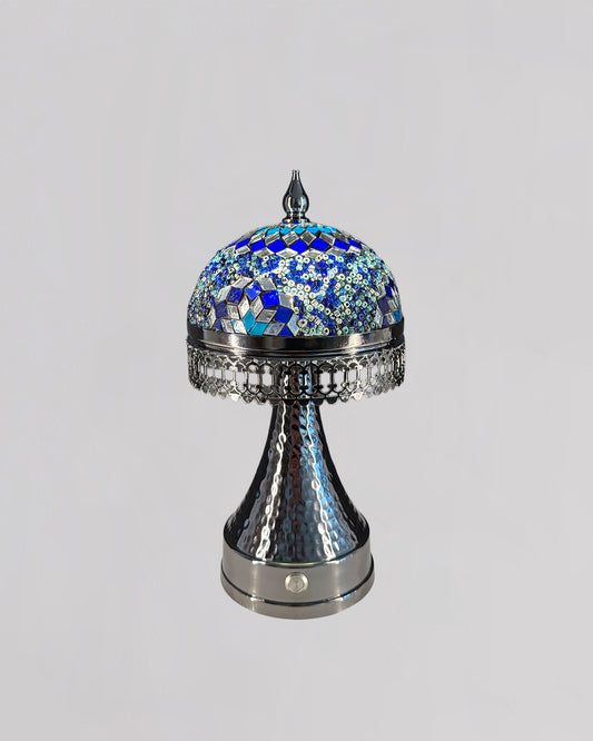 Decorative lamp with blue mosaic top on a gray background