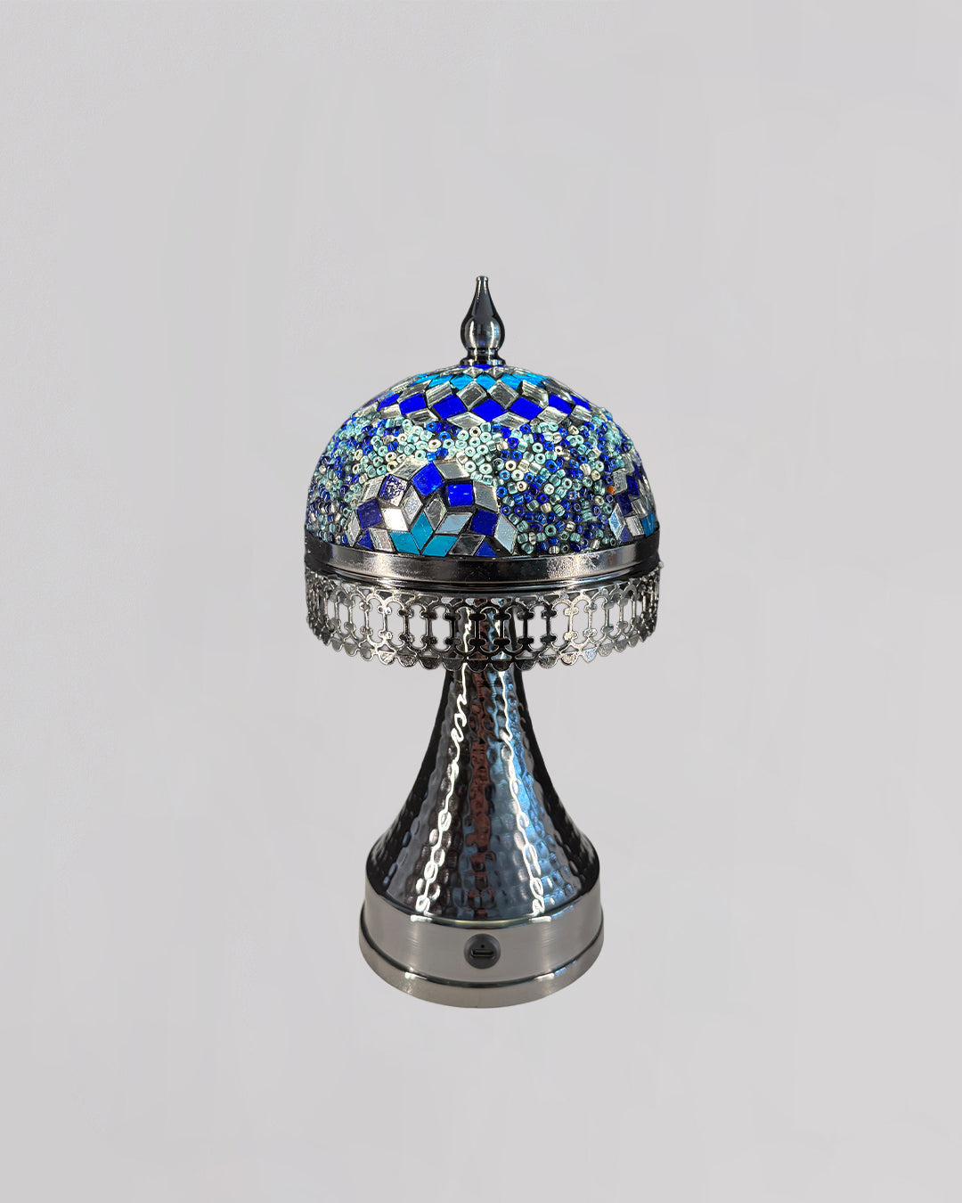 Decorative lamp with blue mosaic top on a gray background