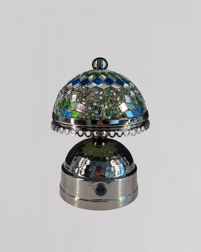 Decorative bell with mosaic top on a gray background