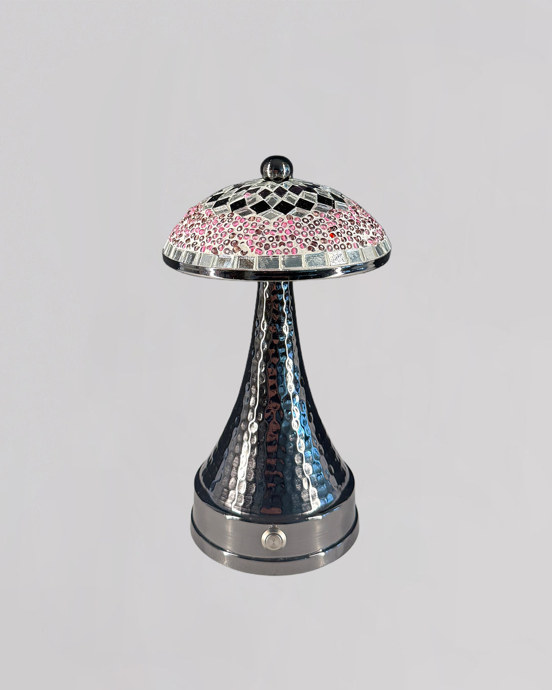 Decorative lamp with a checkered pink and silver shade on a gray background