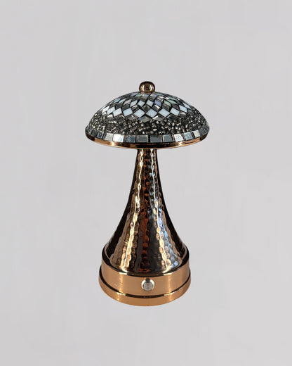 Decorative lamp with mosaic top and textured base on a light gray background