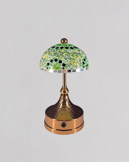 Decorative table lamp with mosaic green shade on a gray background