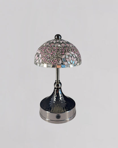 Decorative table lamp with a mosaic glass shade on a gray background
