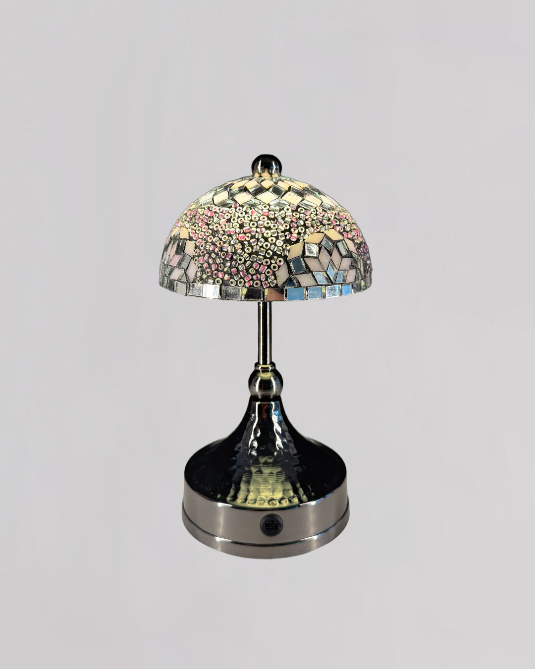 Decorative table lamp with mosaic glass shade on a gray background