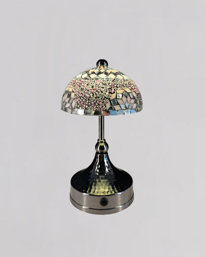 Decorative table lamp with mosaic glass shade on a gray background