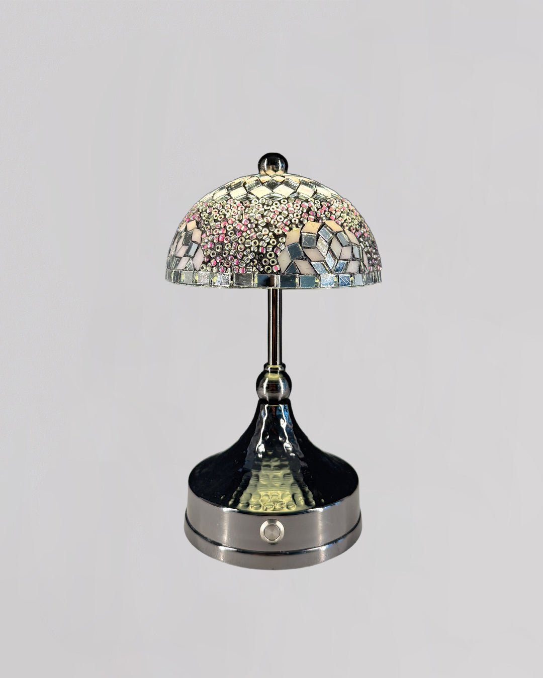 Decorative table lamp with mosaic glass shade on a gray background