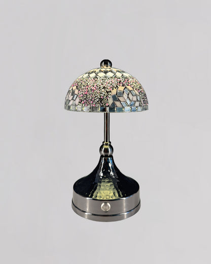 Decorative table lamp with mosaic glass shade on a gray background