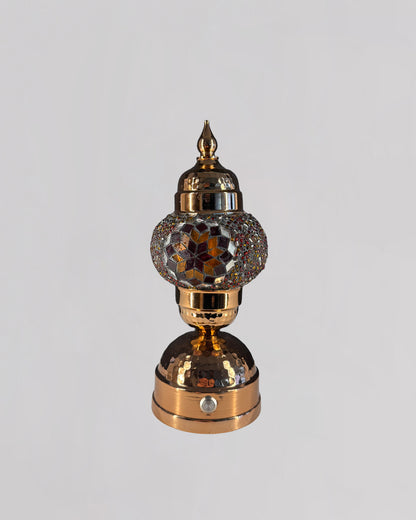 Decorative lamp with intricate design on a gray background