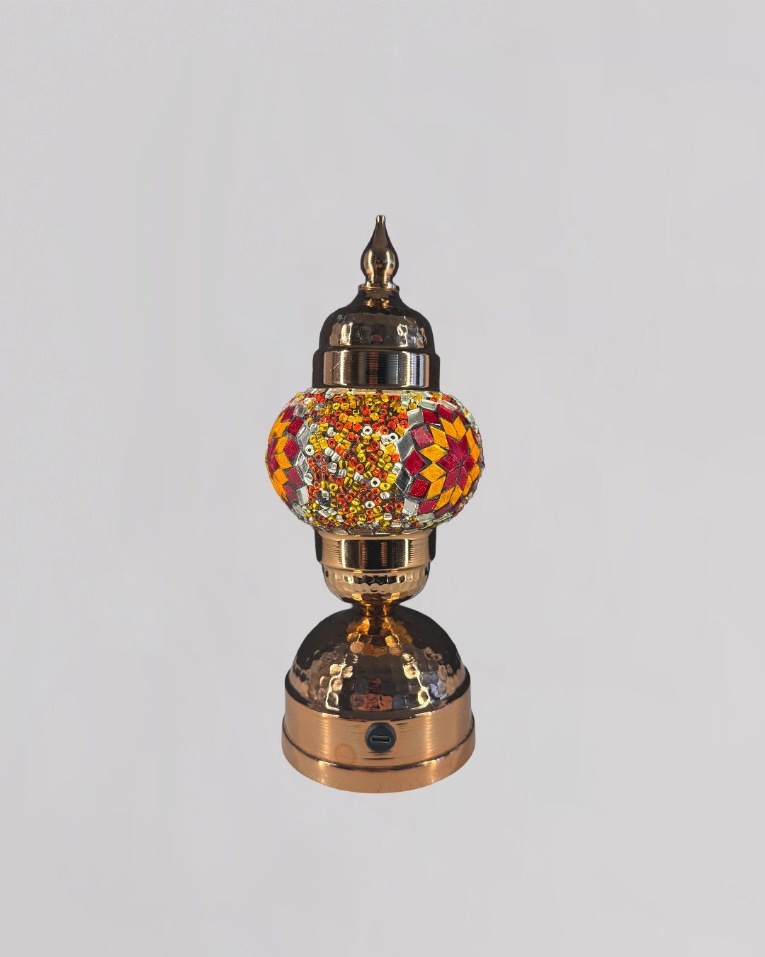 Decorative lamp with a colorful glass shade on a white background