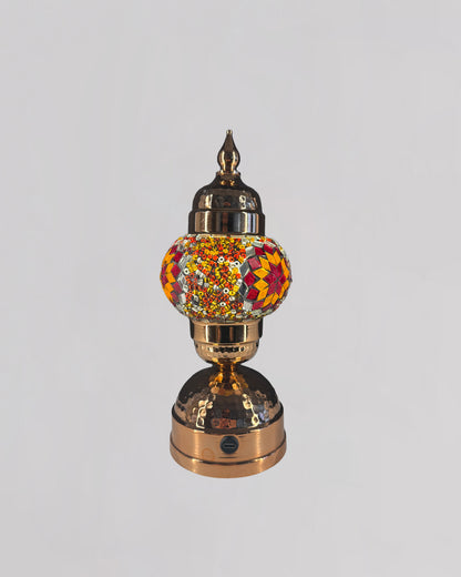 Decorative lamp with a colorful glass shade on a white background