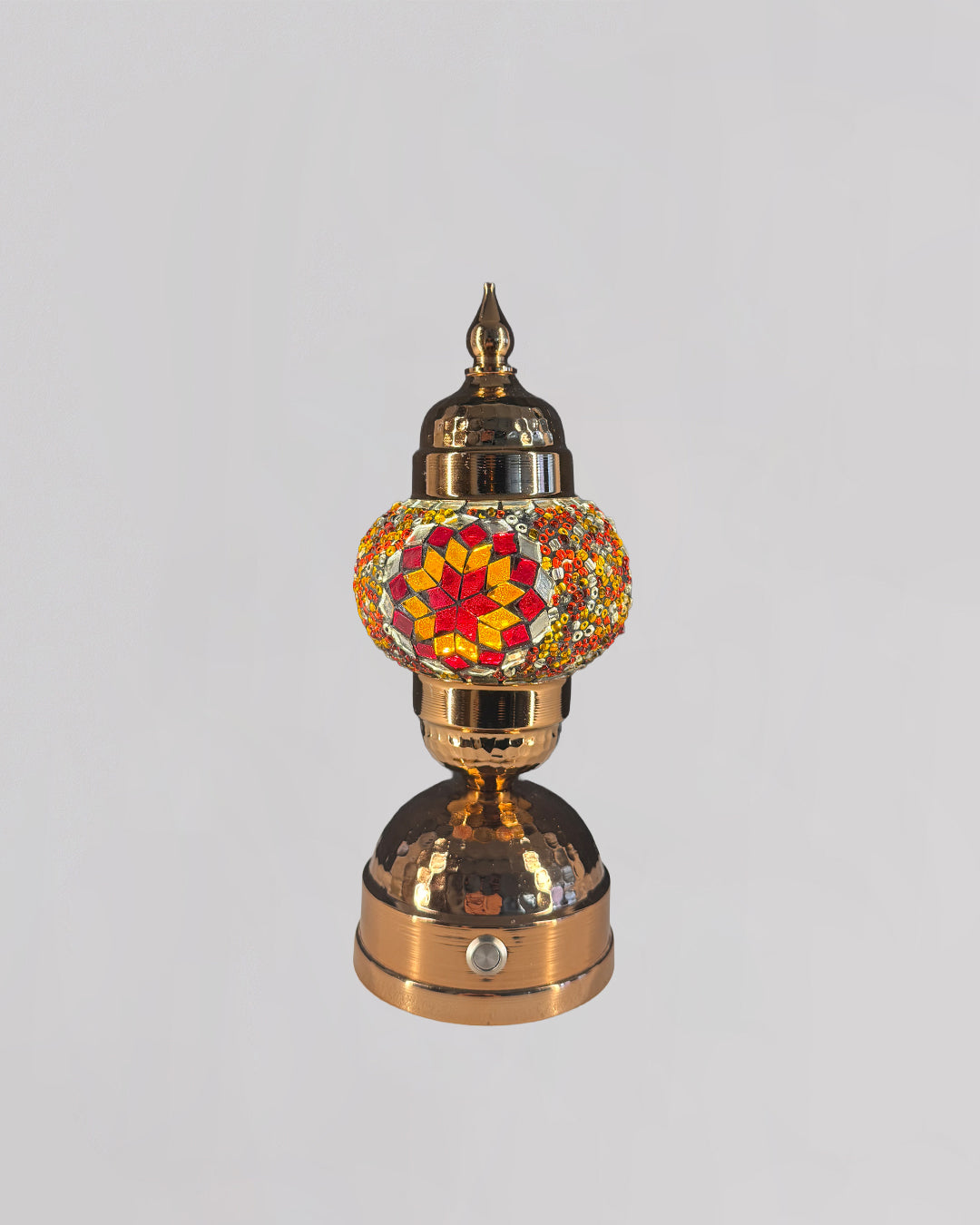 Decorative lamp with a colorful glass shade on a gray background