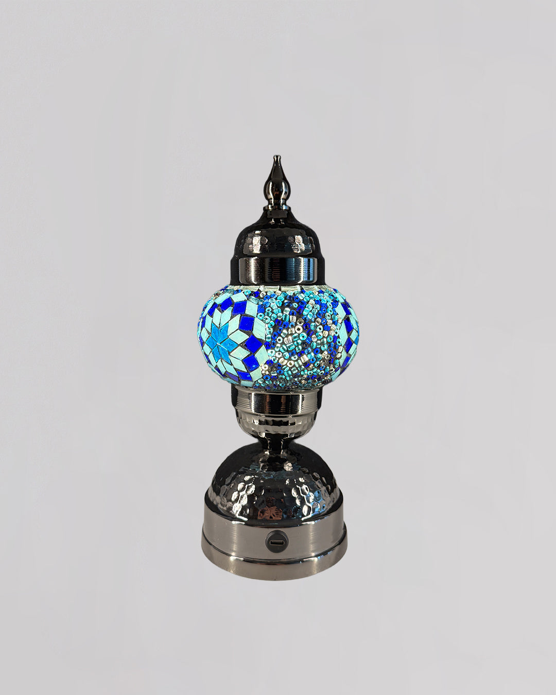 Decorative lamp with a blue mosaic globe on a gray background