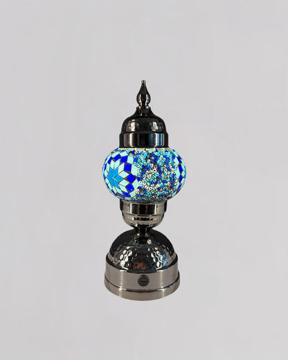 Decorative lamp with a blue mosaic globe on a gray background