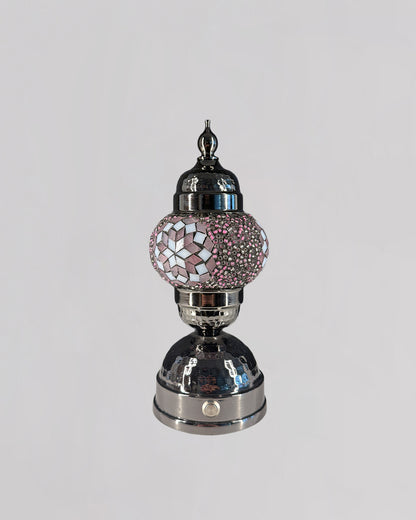 Decorative lamp with pink mosaic top on a white background