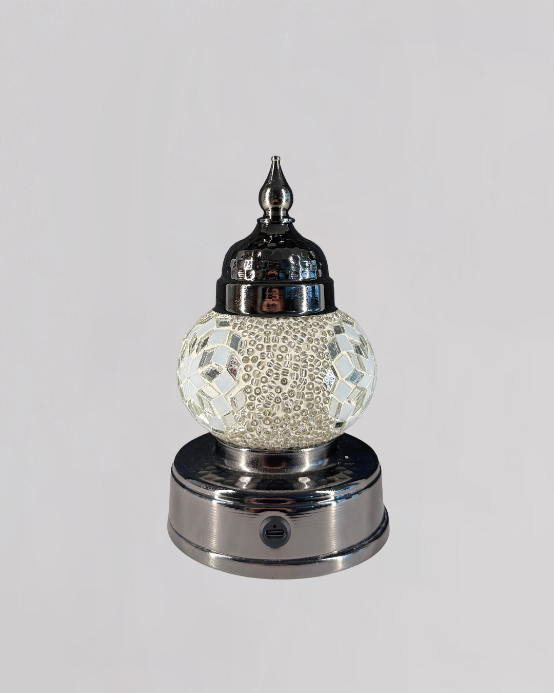 Decorative lamp with mosaic design on a white background