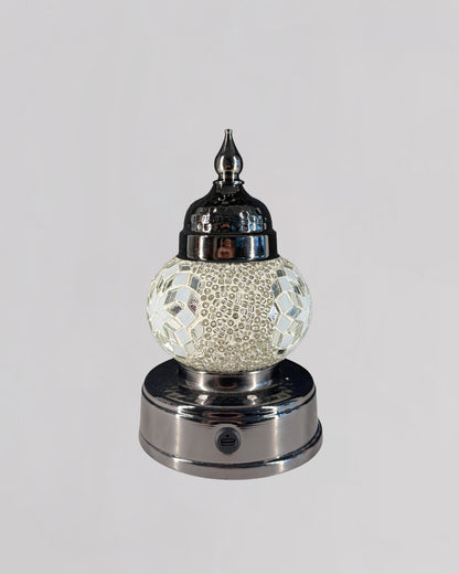 Decorative lamp with mosaic design on a white background
