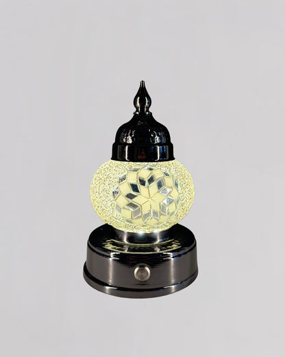 Decorative lamp with a glass shade on a gray background