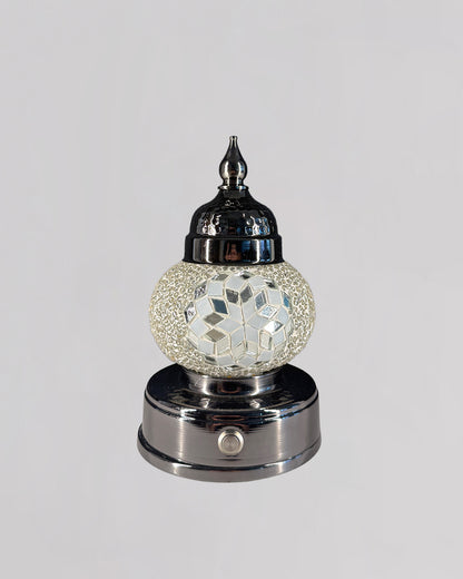 Decorative lamp with mosaic design on a white background