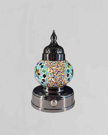 Decorative lamp with mosaic design on a white background