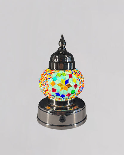 Decorative lamp with colorful mosaic design on a white background